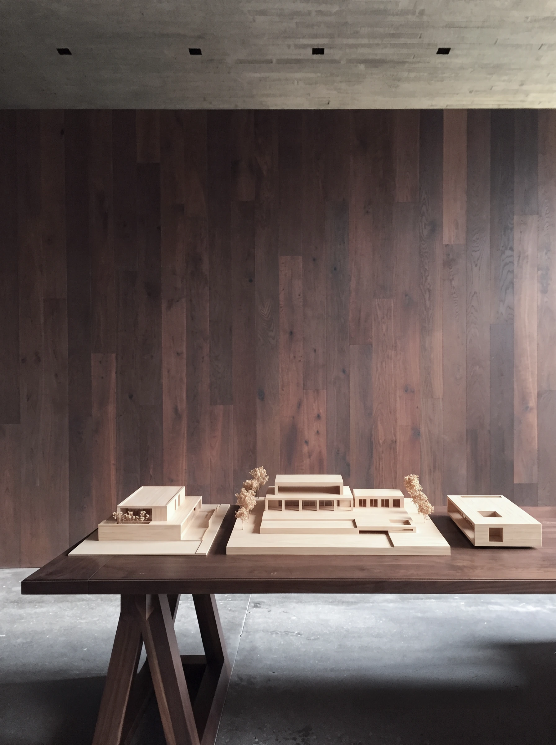 Wooden architectural models on a walnut table